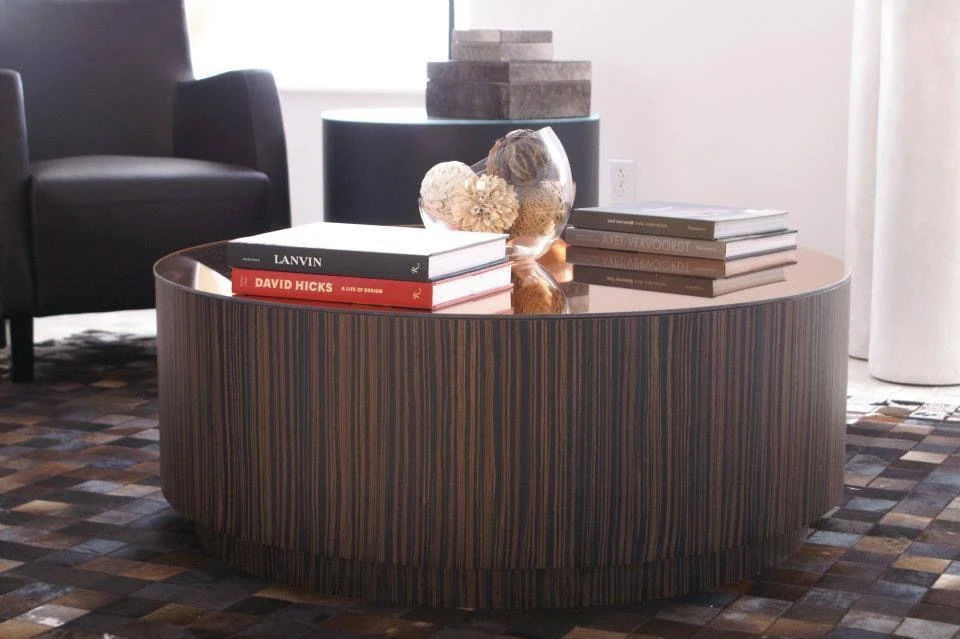 Round wood coffee table with a striped veneer base